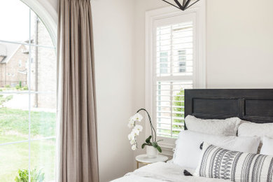 Mid-sized transitional guest light wood floor and beige floor bedroom photo in Charlotte with beige walls