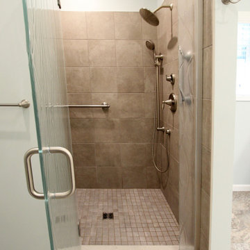 Warm Gray Vanity with Maple Truffle Accent Linen Cabinet and Tiled Shower