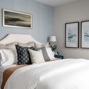 Coastal Inspired Guest Bedroom With Blue Grasscloth Wallpaper And Bedside Sconce
