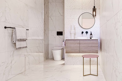Mid-sized modern master bathroom in Melbourne with flat-panel cabinets, light wood cabinets, a curbless shower, a wall-mount toilet, white tile, porcelain tile, white walls, porcelain floors, a drop-in sink, solid surface benchtops, white floor, an open shower and white benchtops.