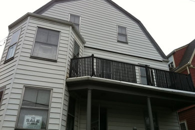 Inspiration for a large contemporary gray three-story wood exterior home remodel in Boston with a gambrel roof