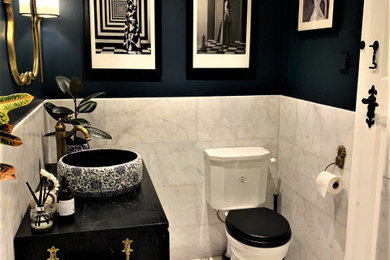 Inspiration for an eclectic master white tile and marble tile marble floor, white floor and single-sink bathroom remodel in London with dark wood cabinets, blue walls and a freestanding vanity