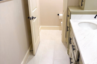 Inspiration for a mid-sized modern master ceramic tile, gray floor and double-sink bathroom remodel in Houston with gray cabinets, beige walls, an undermount sink, granite countertops, white countertops and a built-in vanity