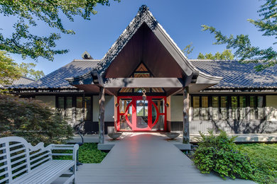 Zen gray one-story stucco gable roof photo in Other with a tile roof
