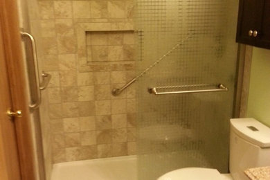 Bathroom - small transitional 3/4 porcelain tile and beige floor bathroom idea in Other with dark wood cabinets, a two-piece toilet, green walls, an undermount sink and solid surface countertops