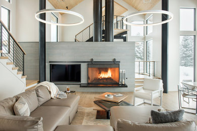 Inspiration for a large contemporary open concept light wood floor, brown floor and wood ceiling living room remodel in Other with white walls, a wood stove and a tile fireplace
