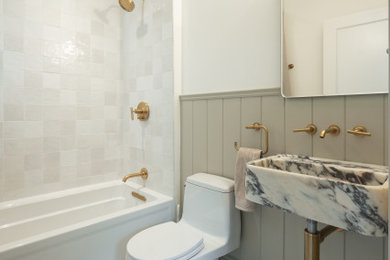 Small transitional 3/4 white tile and ceramic tile marble floor, white floor and wainscoting bathroom photo in San Francisco with a one-piece toilet, white walls, a vessel sink, marble countertops, white countertops and a floating vanity