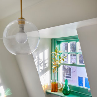 This is an example of a mid-sized midcentury hallway in London with white walls.