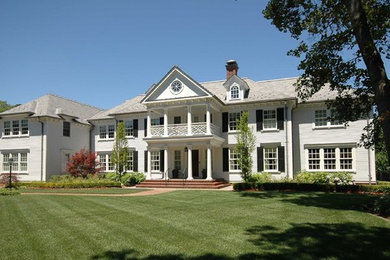 Elegant white two-story wood exterior home photo in New York