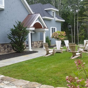 An extensive landscape project with stonewalls, patio, dry river bed & more