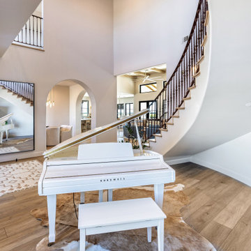 Foyer Curved Staircase and Grand Piano | Tuscan Farmhouse
