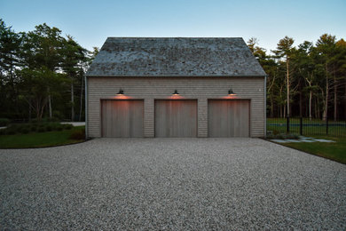 Large transitional attached three-car garage photo in New York