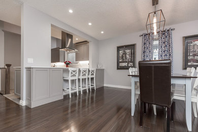 Kitchen/dining room combo - mid-sized transitional dark wood floor and brown floor kitchen/dining room combo idea in Calgary with gray walls