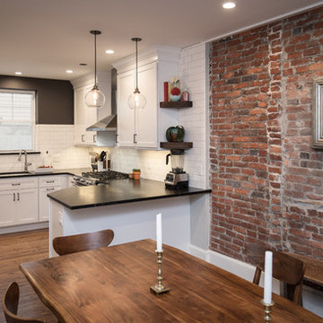 Urban Loft Kitchen Remodel | White Shaker Cabinetry & Exposed Brick
