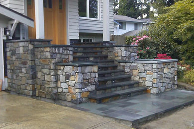 Mid-sized arts and crafts two-story stone house exterior photo in Seattle