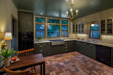 Mid-sized transitional l-shaped brick floor enclosed kitchen photo in Austin with an undermount sink, beaded inset cabinets, black cabinets, quartz countertops, white backsplash, stone tile backsplash and black appliances