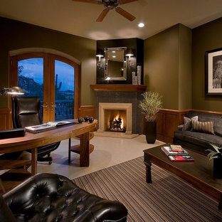 Large modern study in Phoenix with grey walls, a corner fireplace, a stone fireplace surround, a freestanding desk and beige floors.