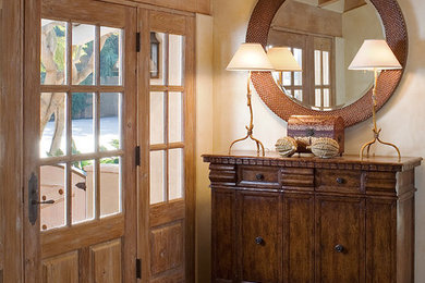 Inspiration for a mid-sized eclectic terra-cotta tile entryway remodel in Los Angeles with white walls and a light wood front door