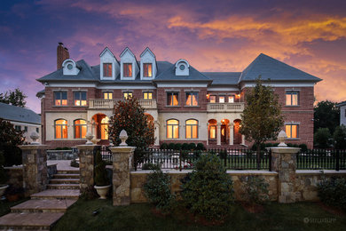 Inspiration for a timeless red two-story brick exterior home remodel in DC Metro with a hip roof