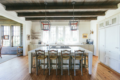 Kitchen - country galley light wood floor kitchen idea in Charleston with recessed-panel cabinets, white cabinets and an island