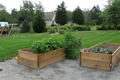 This is an example of a mid-sized modern full sun side yard gravel formal garden in Providence for summer.