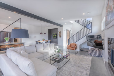 Mid-sized transitional open concept concrete floor, white floor and exposed beam living room photo in Other with white walls, a standard fireplace and a tile fireplace
