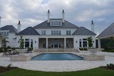 Large elegant backyard stone and rectangular lap pool fountain photo in Jackson