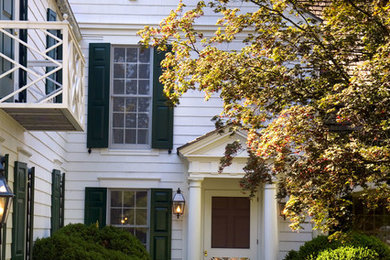 Farmhouse white two-story gable roof idea in New York