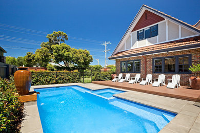 Inspiration for a mid-sized traditional backyard pool in Melbourne.