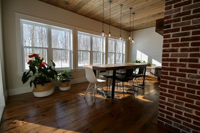 Mid-sized brown floor dining room photo in Ottawa with white walls, a two-sided fireplace and a brick fireplace