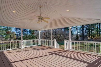 Inspiration for a mid-sized modern courtyard ground level mixed material railing deck remodel in Philadelphia with a roof extension