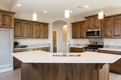 Eat-in kitchen - large transitional ceramic tile and gray floor eat-in kitchen idea in Other with an undermount sink, raised-panel cabinets, gray cabinets, quartz countertops, blue backsplash, ceramic backsplash, stainless steel appliances and an island