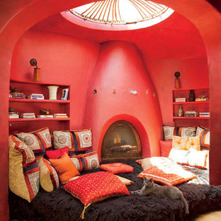 Esempio di un'ampia camera matrimoniale etnica con pareti multicolore e camino ad angolo