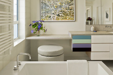 Example of a mid-sized trendy gray tile and mosaic tile mosaic tile floor freestanding bathtub design in San Francisco with an undermount sink, flat-panel cabinets, white cabinets, white walls, a one-piece toilet and granite countertops