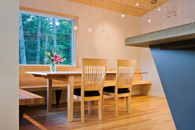 Trendy light wood floor dining room photo in Other with white walls