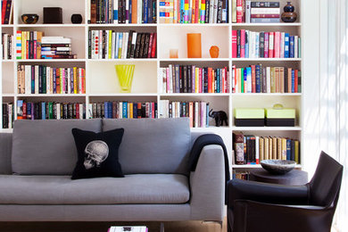 Inspiration for a mid-century modern light wood floor living room library remodel in Philadelphia with white walls