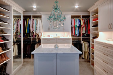 Inspiration for a large traditional gender-neutral walk-in wardrobe in Other with white cabinets, carpet, beige floor and recessed-panel cabinets.
