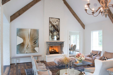 Large farmhouse formal and enclosed dark wood floor and brown floor living room photo in Houston with white walls, a standard fireplace, a plaster fireplace and no tv