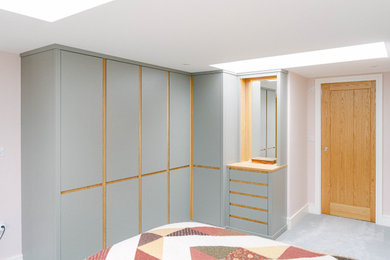 Design ideas for a medium sized modern built-in wardrobe in Gloucestershire with flat-panel cabinets.