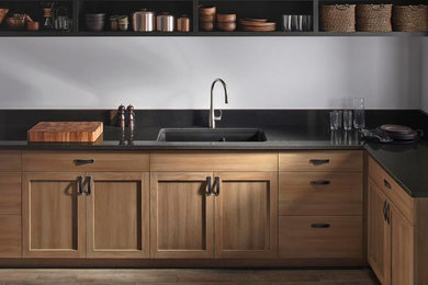 Large minimalist galley light wood floor eat-in kitchen photo in Boston with a drop-in sink, raised-panel cabinets, light wood cabinets, marble countertops, stainless steel appliances and no island