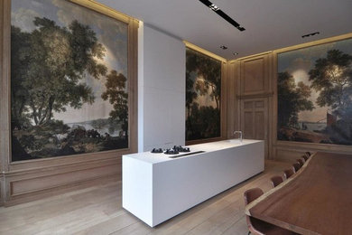 Example of a medium tone wood floor kitchen design in Amsterdam with an island and an integrated sink