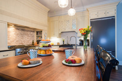 Eat-in kitchen - huge cottage l-shaped medium tone wood floor eat-in kitchen idea in Charleston with raised-panel cabinets, white cabinets, multicolored backsplash, subway tile backsplash, stainless steel appliances and an island