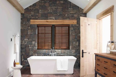 Design ideas for a mid-sized country master bathroom in Denver with medium wood cabinets, wood benchtops, a freestanding tub, white walls, dark hardwood floors, a vessel sink, brown benchtops and flat-panel cabinets.