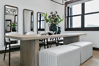 Mid-sized trendy vinyl floor and brown floor kitchen/dining room combo photo in Boise with white walls and a two-sided fireplace