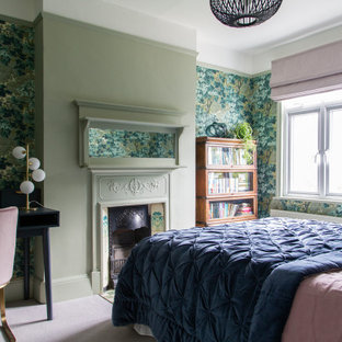 Inspiration for a transitional bedroom in London with green walls, carpet, a standard fireplace and pink floor.