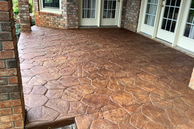 Inspiration for a mid-sized timeless backyard concrete patio remodel in Other with a roof extension