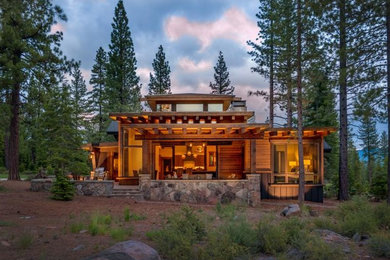 Large trendy brown two-story wood flat roof photo in Sacramento