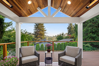 Inspiration for a large contemporary backyard second story mixed material railing deck remodel in Seattle with a roof extension