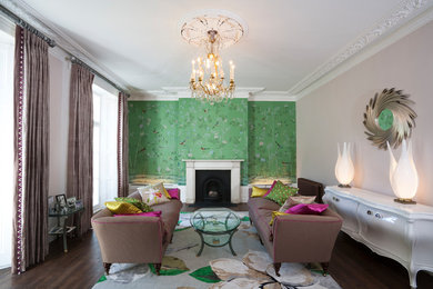Design ideas for a classic formal enclosed living room in London with green walls, dark hardwood flooring, a standard fireplace, a stone fireplace surround and no tv.