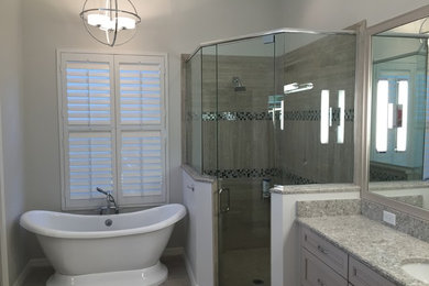 Bathroom - large contemporary master gray tile porcelain tile bathroom idea in Tampa with recessed-panel cabinets, gray cabinets, gray walls, an undermount sink and quartz countertops